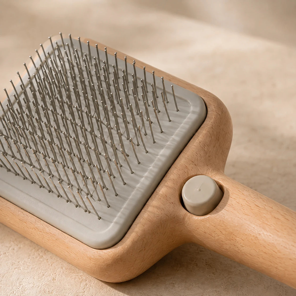 Grooming Brush — close detail: Retracting pins for one-press cleaning